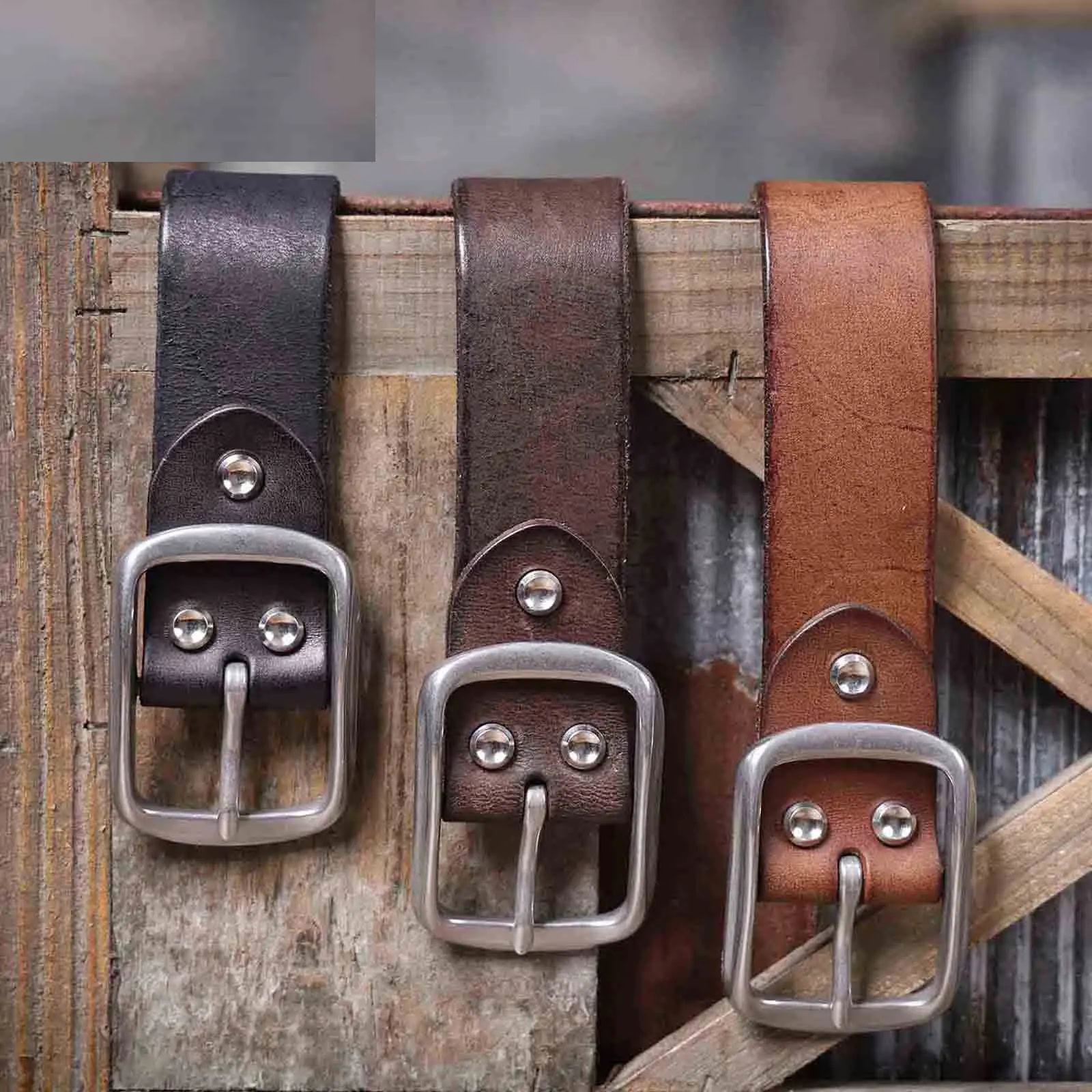 Leather Belts with Stainless Steel Buckles for Men Leather belts with stainless steel buckles displayed on a rustic wooden surface.
