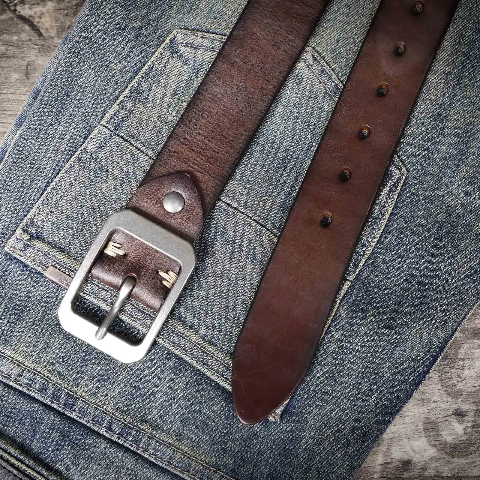 Leather Men’s Cowhide Belt for Casual and Formal Wear Genuine leather men's cowhide belt with metal buckle on denim background.
