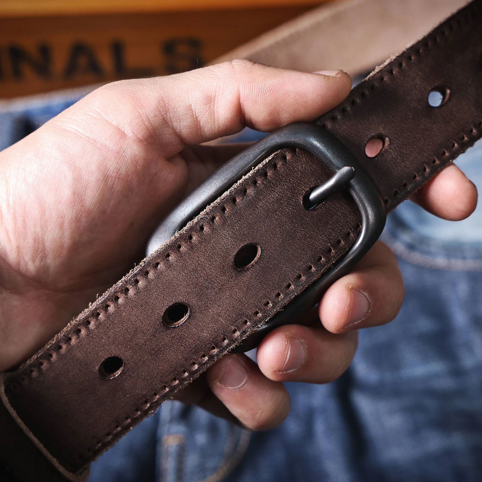 Men’s Denim Belt with Pin Buckle Close-up of men's denim belt with casual pin buckle for jeans.