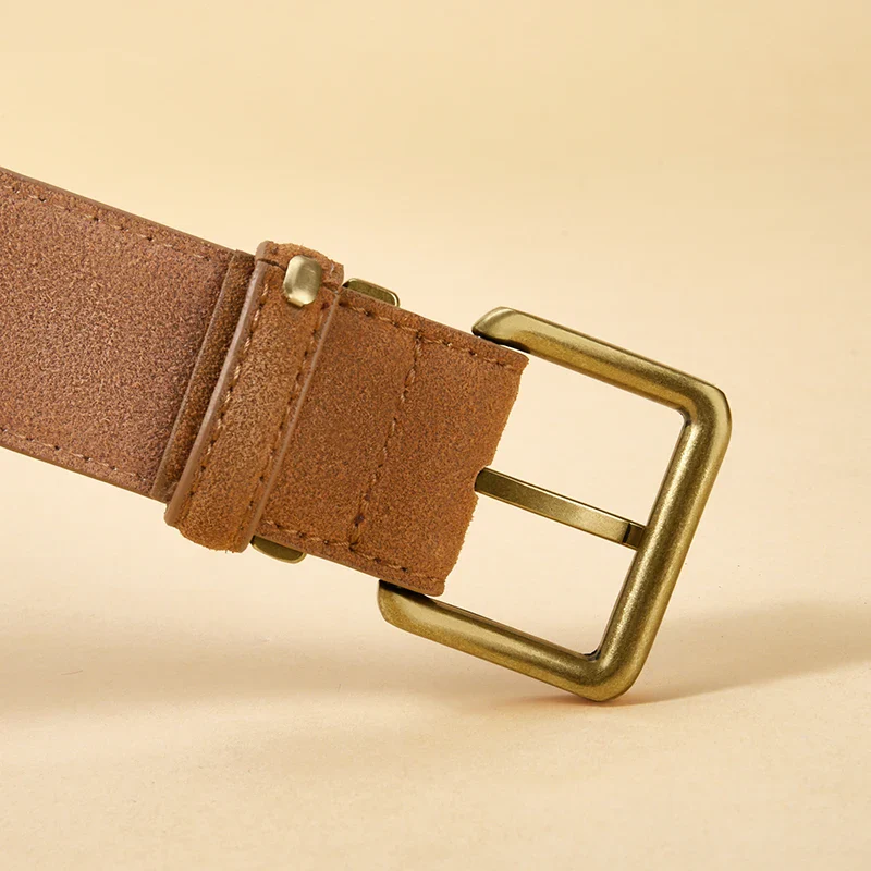 Leather belt with gold buckle for luxury fashion accessories. Elegant suede cowhide belt with a gold buckle, perfect for upscale outfits.