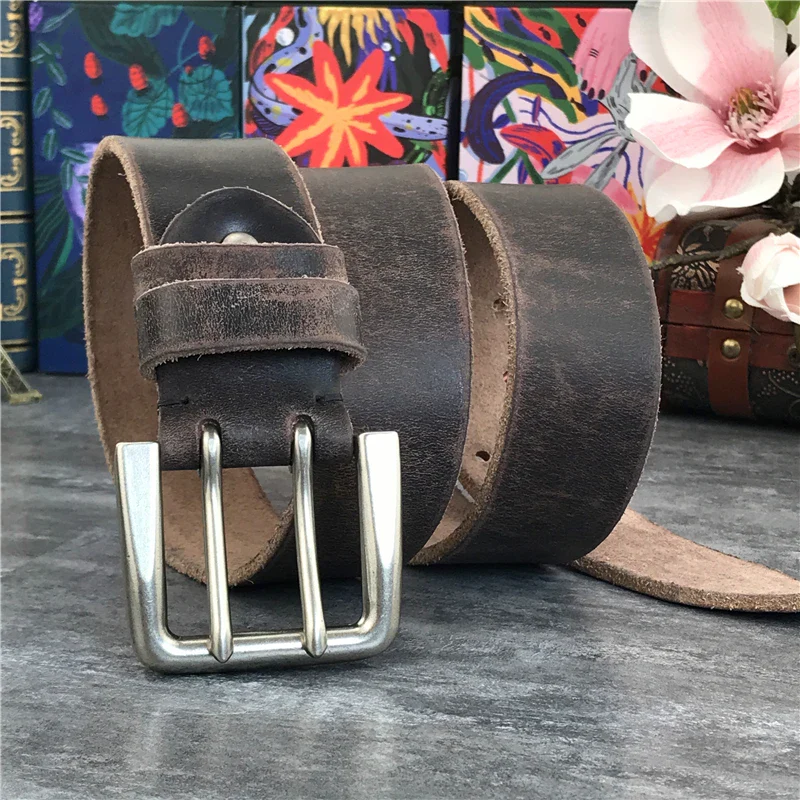 Vintage genuine cowhide double-pin belt with sturdy metal buckle. Durable leather belt featuring a double-pin buckle for secure fit and classic style.