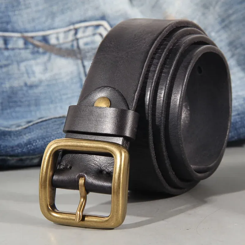 Leather belt with brass buckle and denim jeans in the background Leather belt with brass buckle, styled with denim jeans for casual wear.