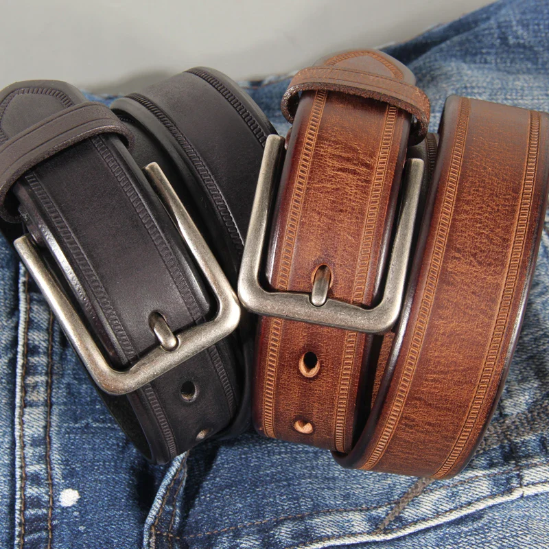 Black and brown full-grain leather belts displayed on denim. High-quality full-grain leather belts in black and brown, perfect for stylish everyday wear.