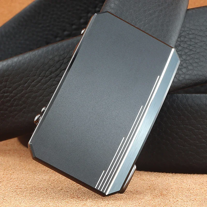 Tail Leather Belt Close-up of a sleek black leather belt with a hidden-tail ratchet buckle.