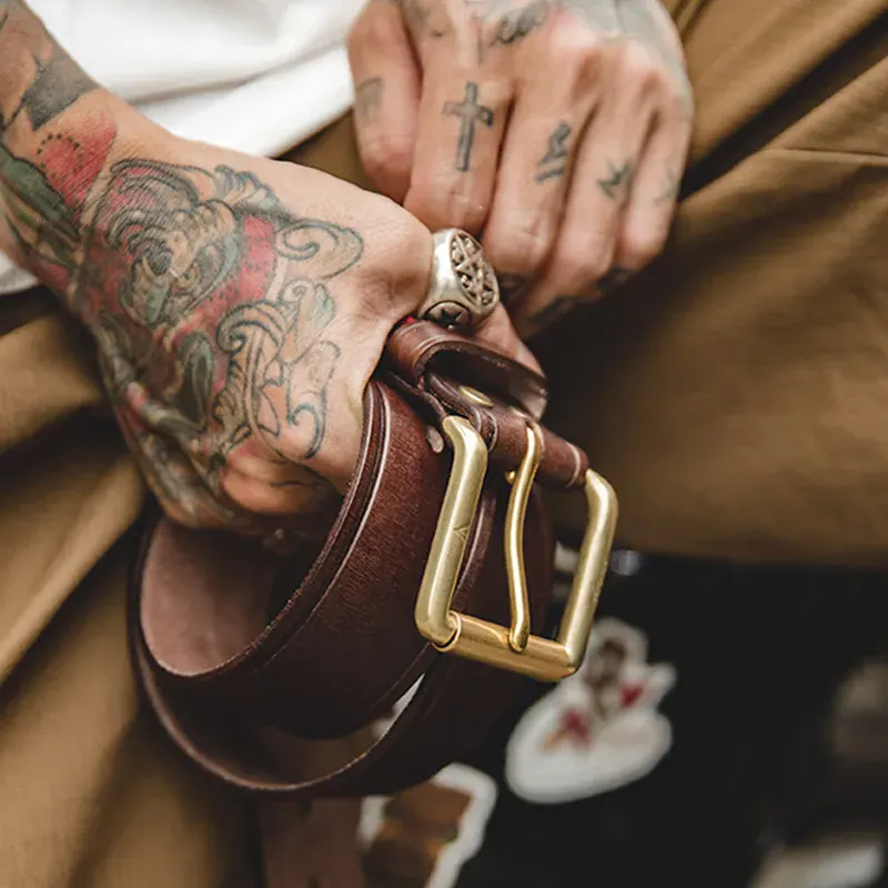 Leather Men’s Belt with Pin Buckle for Fashion and Style Close-up of a leather men's belt with a gold pin buckle, showcasing high-quality craftsmanship.