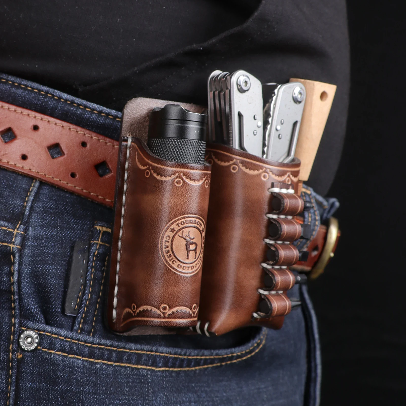 Leather belt holster with folding knife, flashlight, and multi-tool for outdoor use. Durable leather belt pouch designed for camping, construction, and outdoor activities.