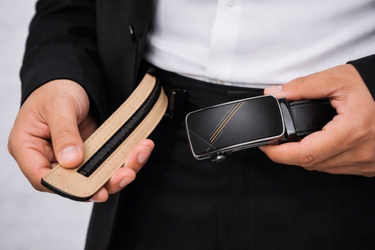 Ratchet belt mechanism with a leather strap and secure buckle.